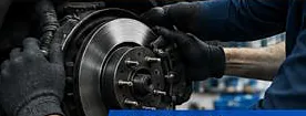 Mechanic fitting a new brake disc